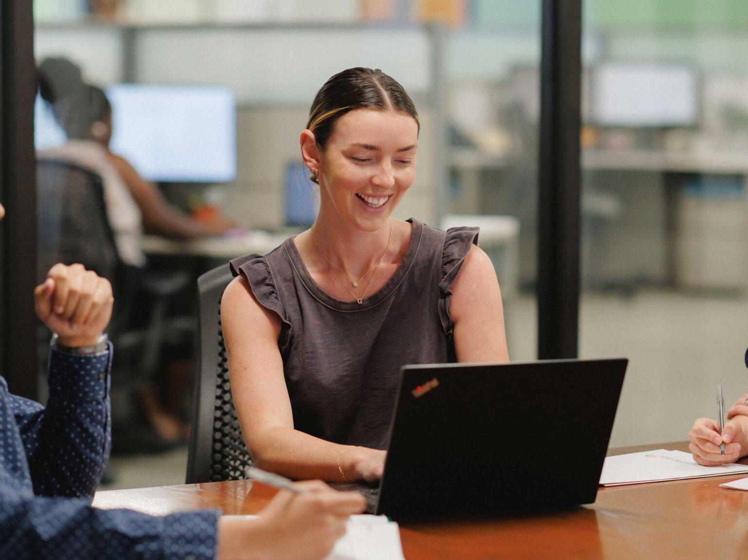 Healthgram employee smiling looking at laptop screen